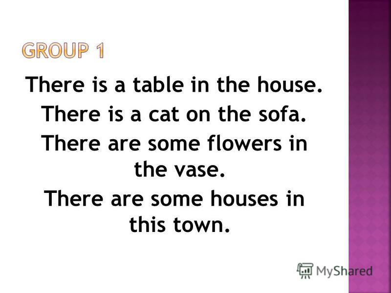 There is a table in the house. There is a cat on the sofa. There are some flowers in the vase. There are some houses in this town.