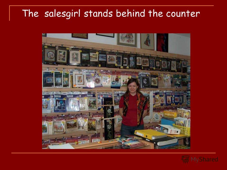 The salesgirl stands behind the counter